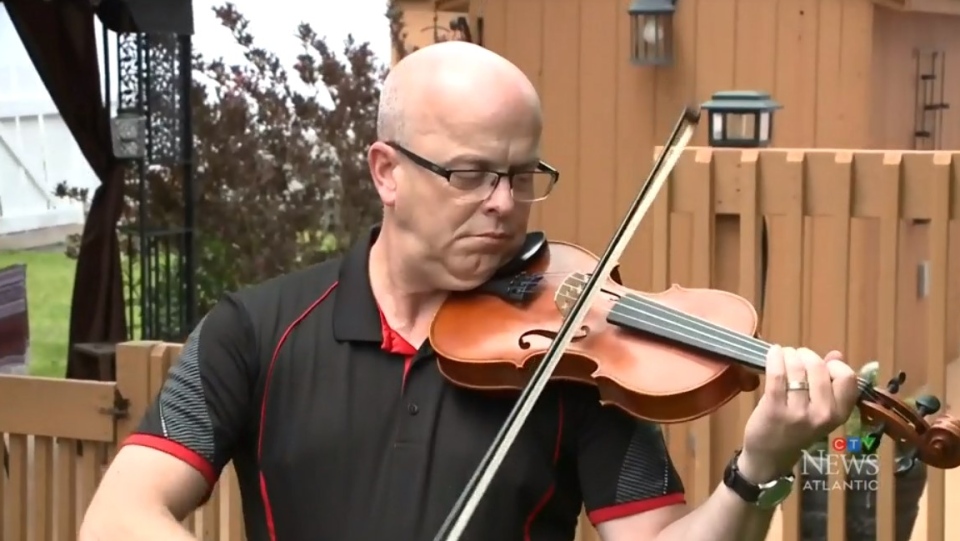 Music teacher Shawn MacDonald, who taught Nova Scotia shooting victim Emily Tuck, plays a fiddle donated in her memory.